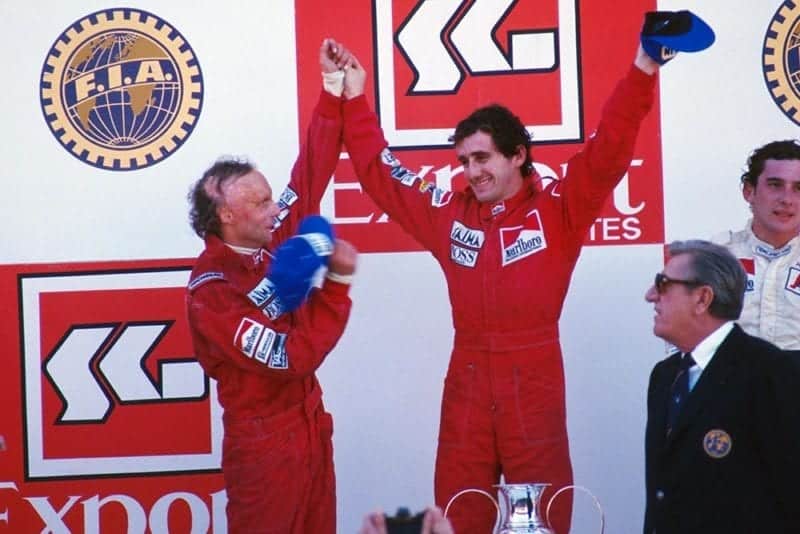 Alain Prost, 1st, (centre) with second place Niki Lauda, left, and third place Ayrton Senna, right on the podium.