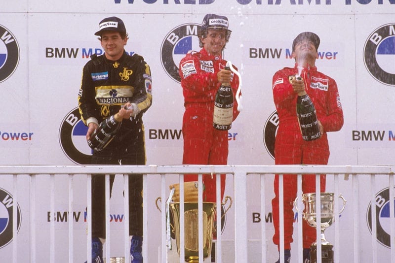 Alain Prost, 1st position, Ayrton Senna, 2nd position and Michele Alboreto, 3rd position on the podium.