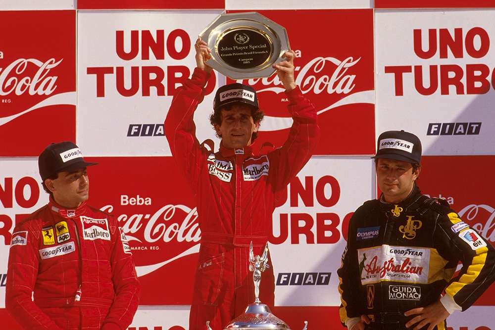 Alain Prost, 1st position, Michele Alboreto, 2nd position and Elio de Angelis, 3rd position on the podium.