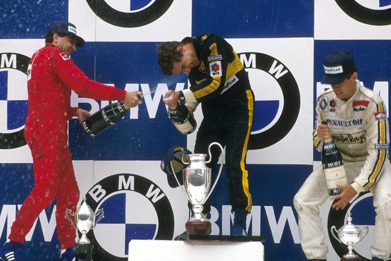 Ayrton Senna 1st position, Michele Alboreto 2nd position and Patrick Tambay 3rd position on the podium.