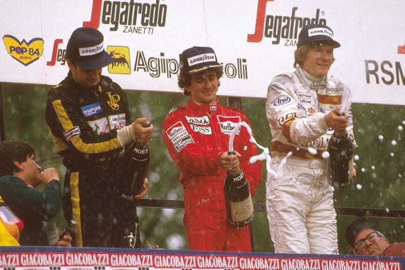 Alain Prost, 1st position but later disqualified due to the car being under weight at the finish, Elio de Angelis 1st position, and Thierry Boutsen 2nd position, on the podium.