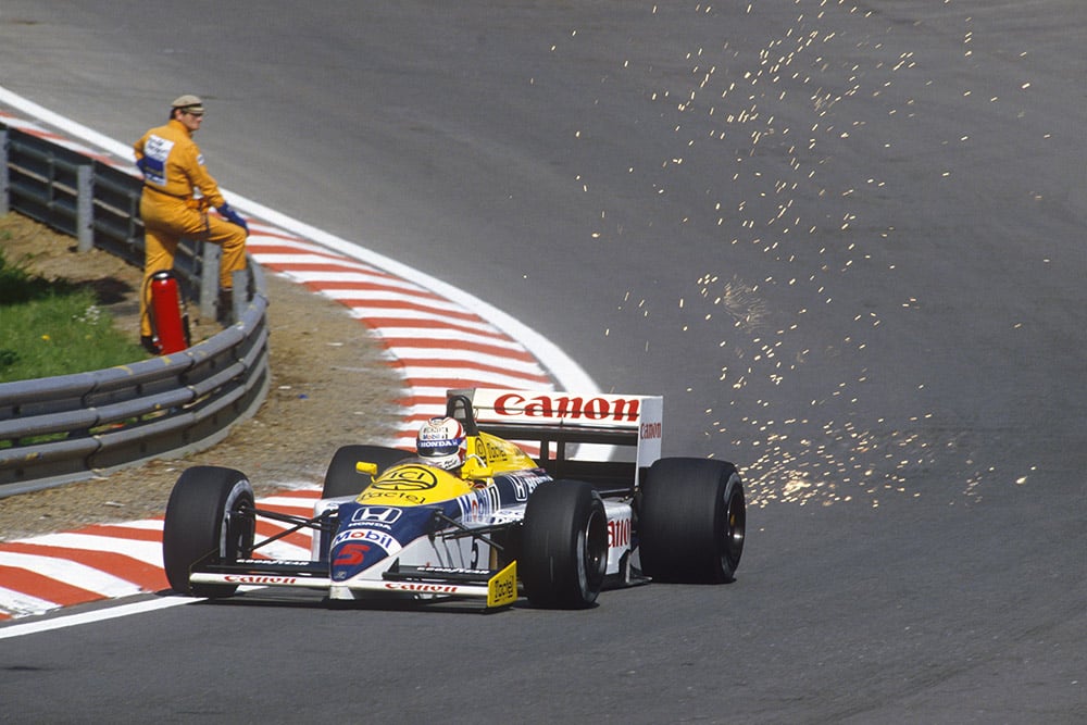 Nigel Mansell showers sparks at Eau Rouge in his Williams FW11 Honda.
