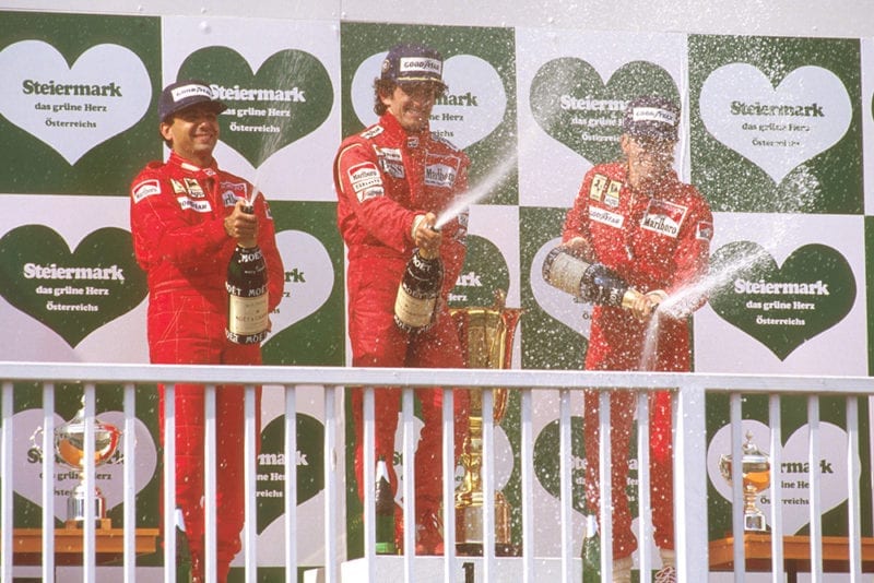 Alain Prost, 1st position, Michele Alboreto, 2nd position and Stefan Johansson, 3rd position on the podium.