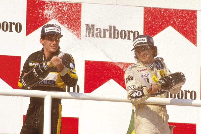 Nelson Piquet, 1st position, with Ayrton Senna, 2nd position on the podium.