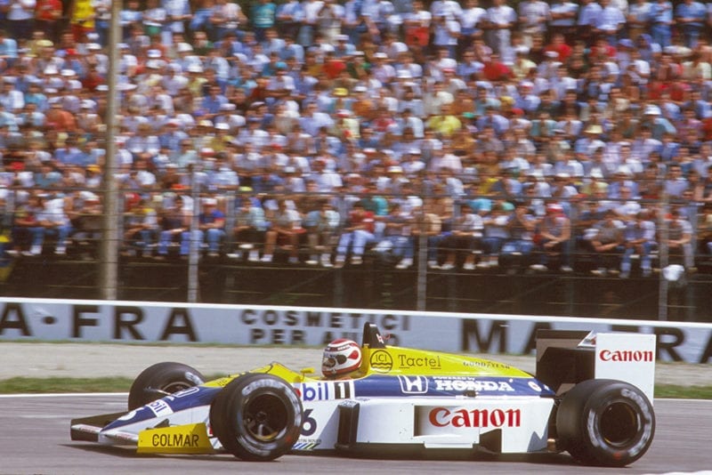 Nelson Piquet leads in his Williams FW11 Honda.