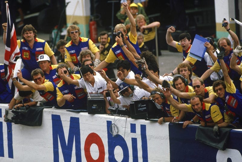 The Williams team celebrate Nigel Mansell's the victory on the pit wall.