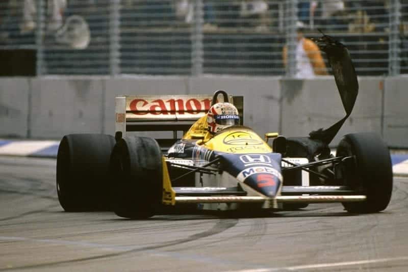 Nigel Mansell saw his World Championship bid end when his rear tyre blew on the Brabham Straight on lap 64.