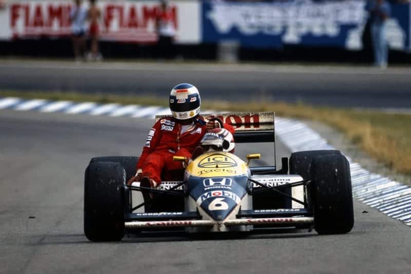 Winner Nelson Piquet gives Keke Rosberg a lift back to the pits.