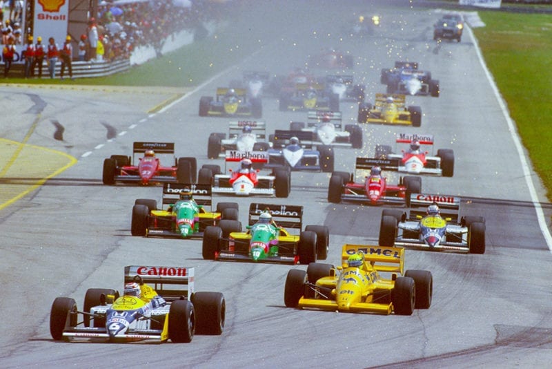 Nelson Piquet (Williams FW11B Honda) leads Ayrton Senna (Lotus 99T Honda), Teo Fabi and Thierry Boutsen (both Benetton B187 Ford's) and Nigel Mansell (Williams FW11B Honda) at the start.