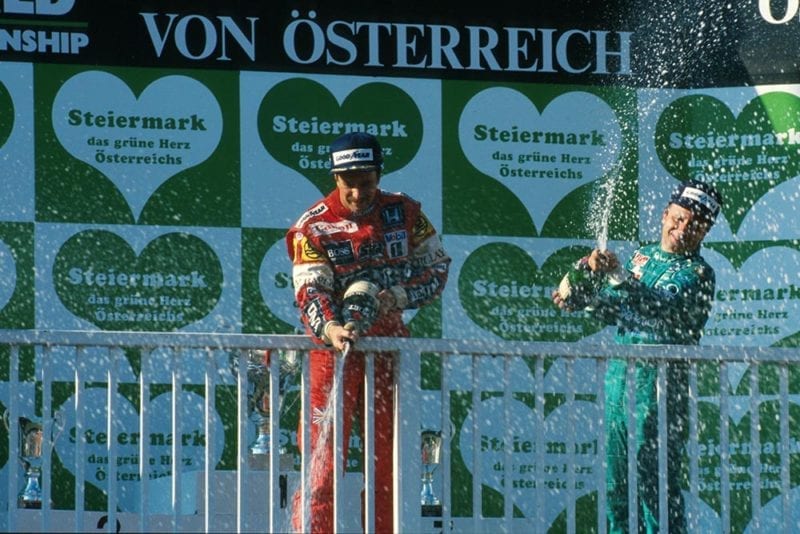 Winner Nigel Mansell and 3rd place Teo Fabi celebrate on the podium.