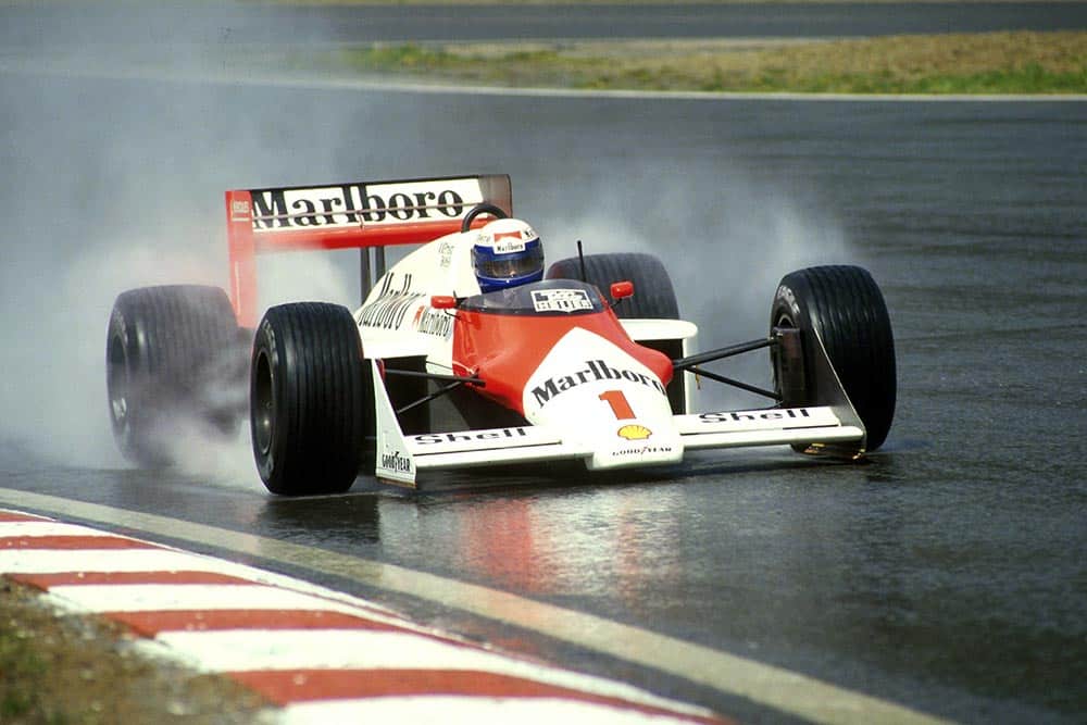 Winner Alain Prost charges through the rain in his Mclaren MP4-3.