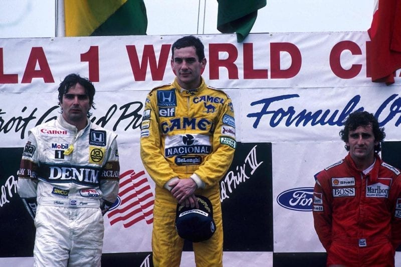Ayrton Senna, 1st place (C), with Nelson Piquet, 2nd (L) and Alain Prost 3rd place (R) on the podium.