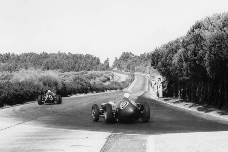 Roy Salvadori in his Aston Martin DBR4/250 chases Stirling Moss in his Cooper T51-Climax
