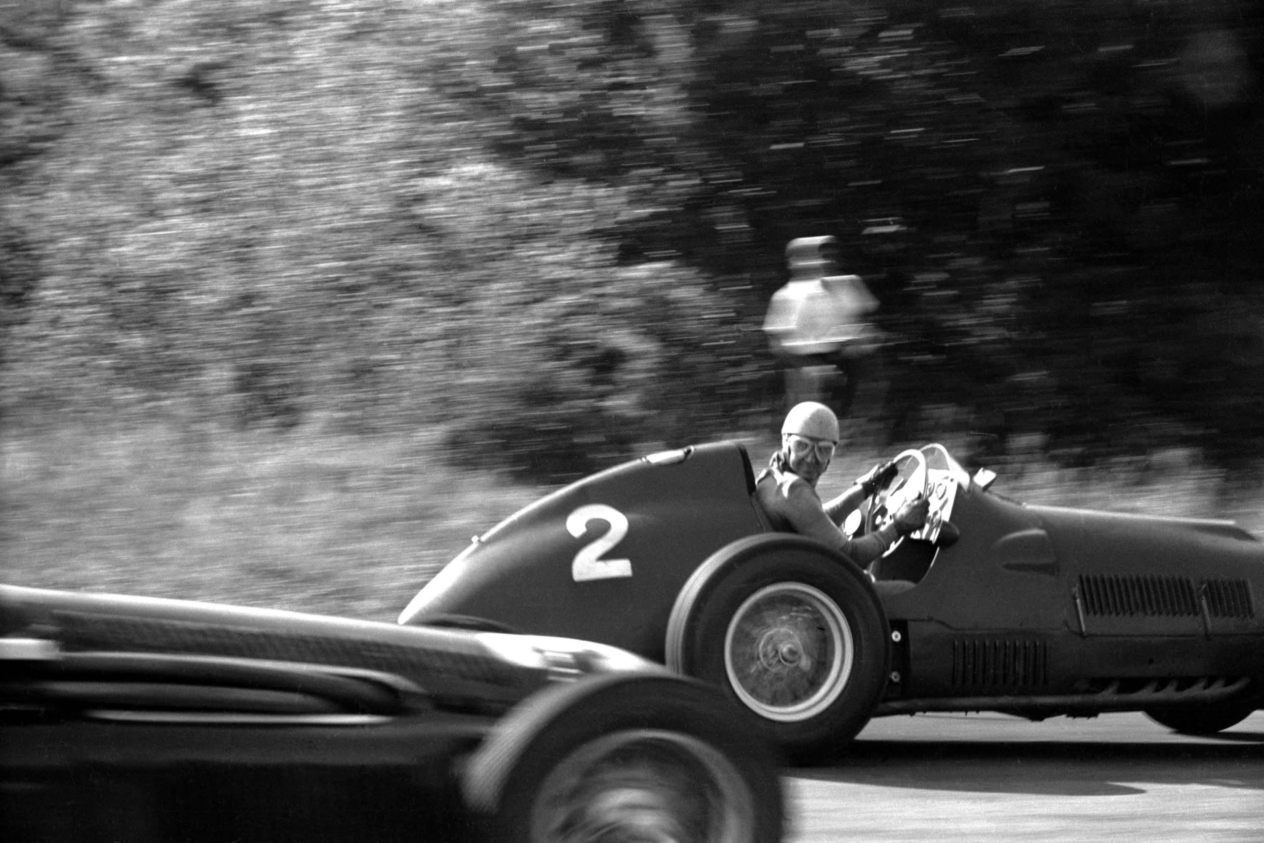 Between the two 'Porfido' corners at Monza (now the Parabolica) Alberto Ascari looks back over his shoulder from his Ferrari 375/F1 and directly into Klemantaski?s camera during the Italian Grand Prix at Monza, 16th September 1951. (Photo by Klemantaski Collection/Getty Images)