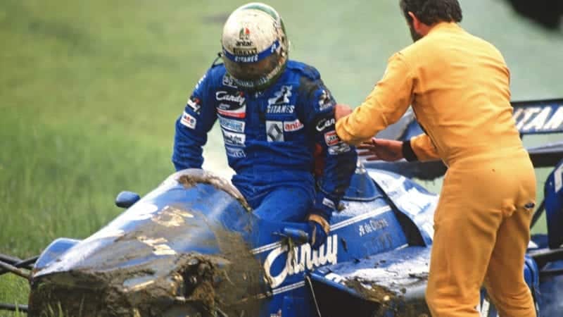 Andrea de Cesaris gets out of his Ligier after crashing in the 1985 Austrian Grand Prix