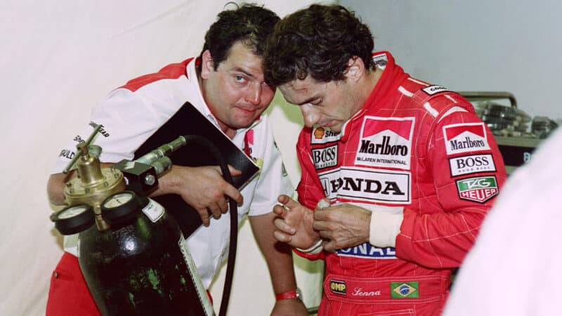 Ayrton Senna talks to McLaren team engineer at the 1992 F1 Canadian GP