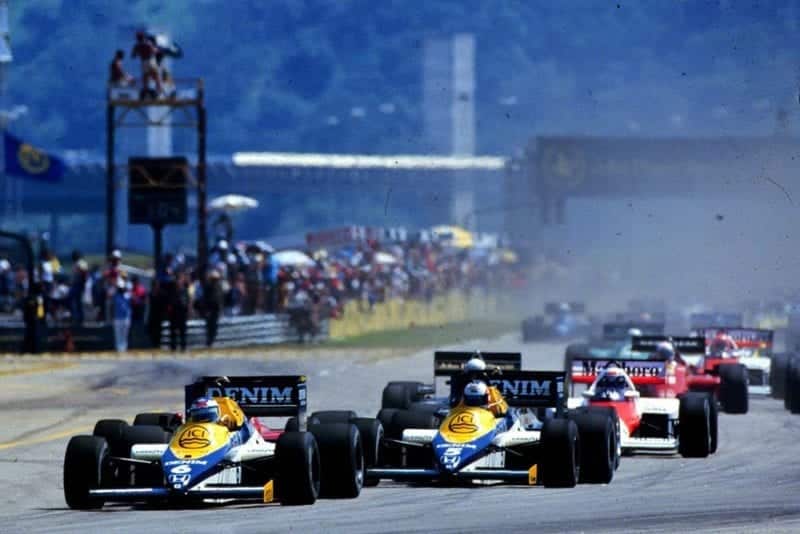 Williams Team mates Nigel Mansell and Keke Rosberg lead away the field at the start of the race.
