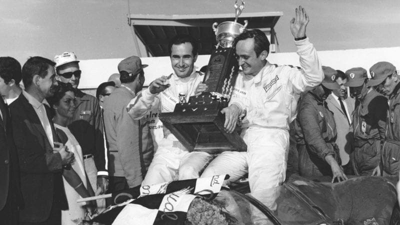 DAYTONA BEACH, FL - FEBRUARY 5, 1967: Lorenzo Bandini and Chris Amon celebrate in victory lane after driving a Ferrari 330 P4 to victory in the 24 Hour Daytona Continental at Daytona International Speedway. (Photo by ISC Images & Archives via Getty Images)