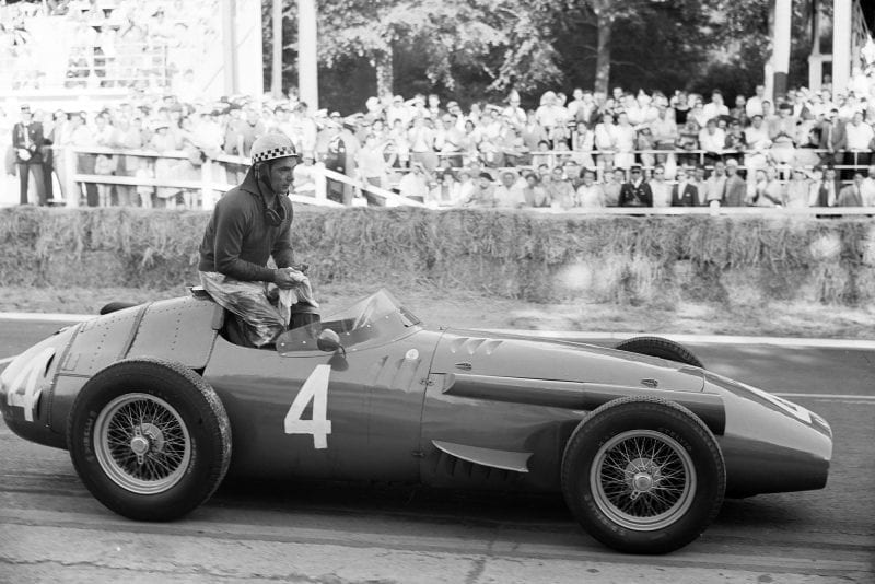 Jean Behra sits on top of his Maserati 250F, 1957 French Grand Prix, Rouen.