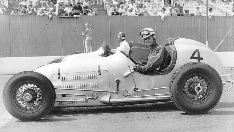 Bob Sweikert (No. 4) looks at the photographer while Bud Rose takes a look toward the grandstands before an early-1950s AAA Pacific Sprint Car race at Oakland Speedwa