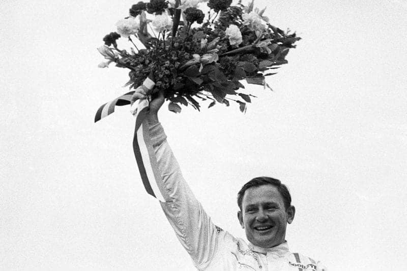 Bruce McLaren celebrates winning the 1968 Belgian Grand Prix in the first win for a McLaren car