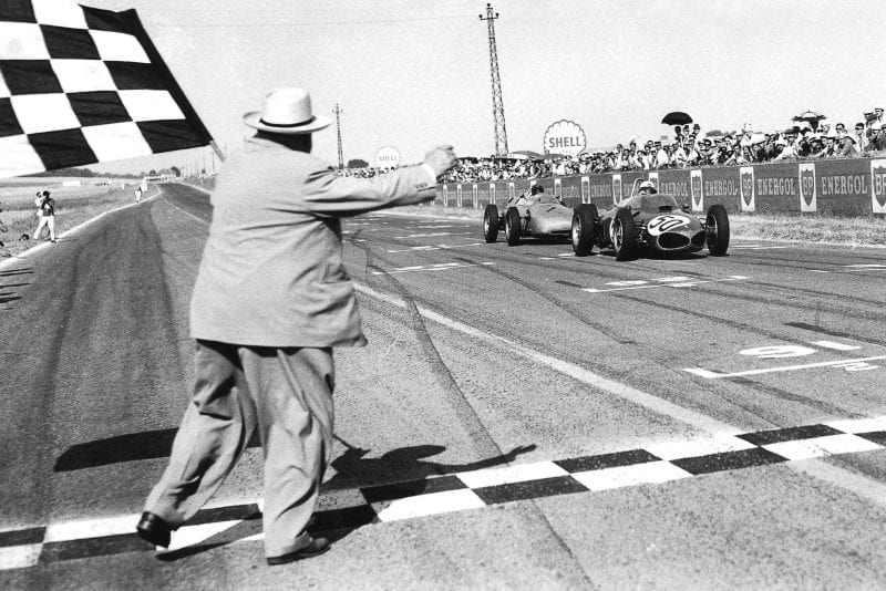 Giancarlo Baghetti in his Ferrari 156 closely followed by Dan Gurney driving a Porsche 718, takes the chequered flag for 1st position and his maiden win on his Grand Prix debut.