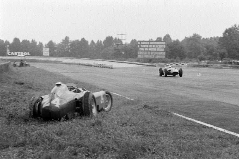 Stirling Moss, Maserati 250F, passes the abandoned Ferrari D50 of Eugenio Castellotti, 1956 Italian Grand Prix, Monza.