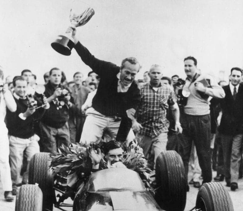 Colin Chapman sits on the back of Jim Clark's Lotus as the pair celebrate winning the 1963 F1 world championship at the Italian Grand Prix