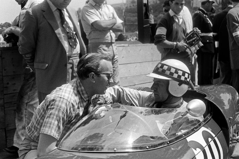 Colin Chapman speaks to Innes Ireland sitting in his Lotus 21 at the 1961 Monaco Grand Prix