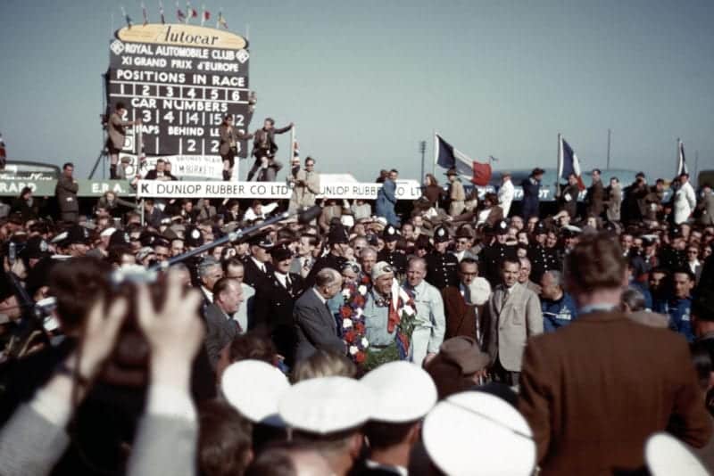 Crowds gather around Giuseppe Farina after he wins the 1950 British Grand Prix