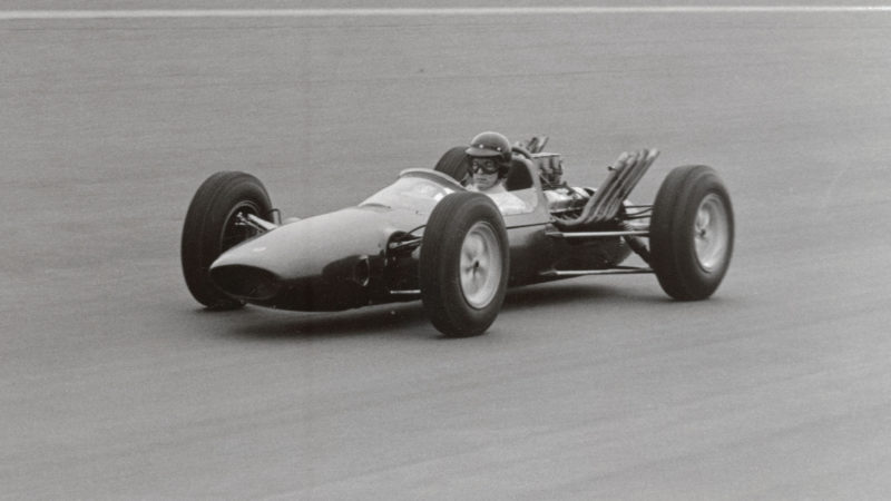 (Original Caption) Indianapolis, IND: Dan Gurney, one of America's great racing drivers, is shown here in the prototype of a new Indianapolis car by Lotus Cars, Ltd. of England. The car is powered by a new Ford aluminum V-8 engine. The car, designed specifically for the