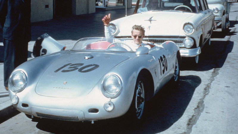 James Dean waves from behind the wheel of his Porsche 550 Spyder 'Little Bastard' numbered 130 (VIN 550-0055) parked on Vine Street in Los Angeles, California, USA. (Photo by Bettmann via Getty Images)
