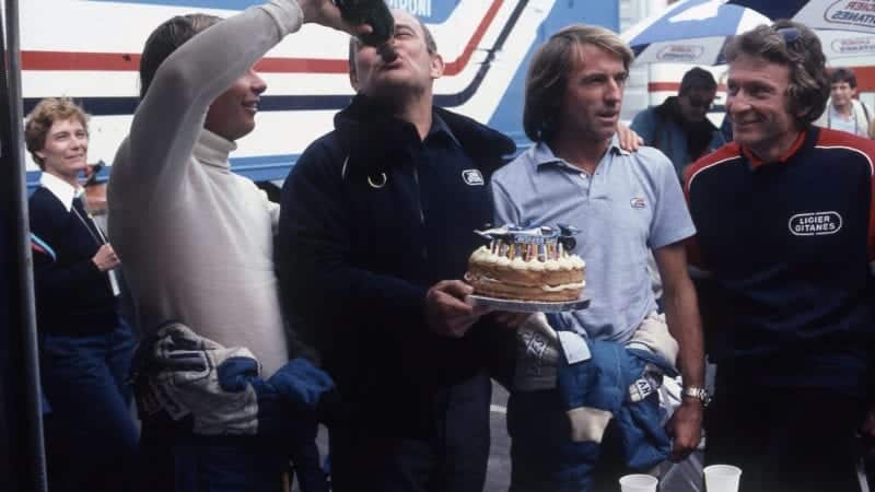 Didier Pironi, Guy Ligier, Jacques Laffite and Gerard Ducarouge with a cake and champagne in 1980