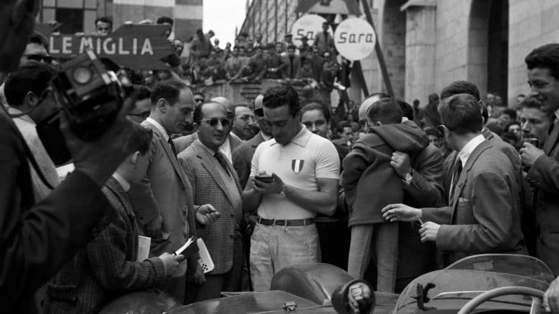 Eugenio-Castellotti-signs-autographs-surrounded-by-crowds-at-the-Mille-Miglia