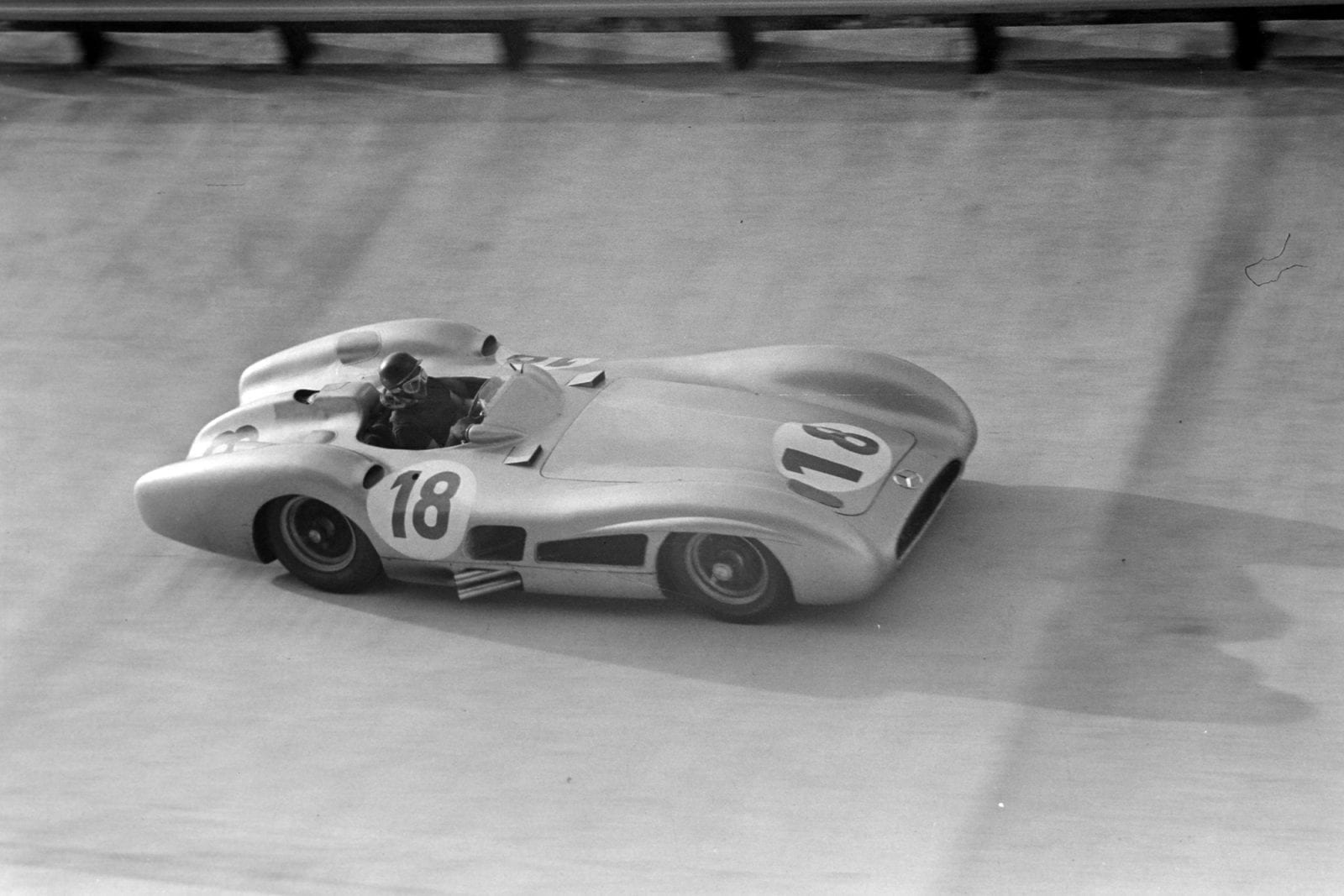 Juan Manuel Fangio takes on the Monza banking in his streamlined Mercedes W196 at the 1955 Italian Grand Prix