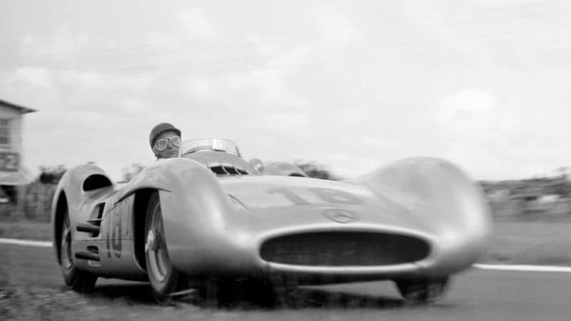 The French Grand Prix; Reims, July 4, 1954. At this race Mercedes introduced their new streamlined W196 Grand Prix cars. The new machine was victorious in this its first outing, with Juan Manuel Fangio, seen here in the ultra-fast right hand bend after the start/finish line, the easy winner ahead of his colleague Karl Kling and the privately-entered Ferrari of Robert Manzon. To some motor racing observers, it was almost as if Mercedes had come back right where they had left off in 1939. Lying on the ground right at the apex, Klemantaski captures Fangio's concentrational sangfroid perfectly. (Photo by Klemantaski Collection/Getty Images)