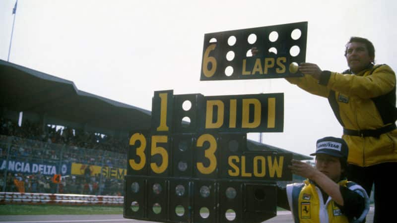 Ferrari mechanics hold out the slow sign for Didier Pironi at Imola where je woild beat Gilles Villeneuve in the 1982 San Marino Grand Prix