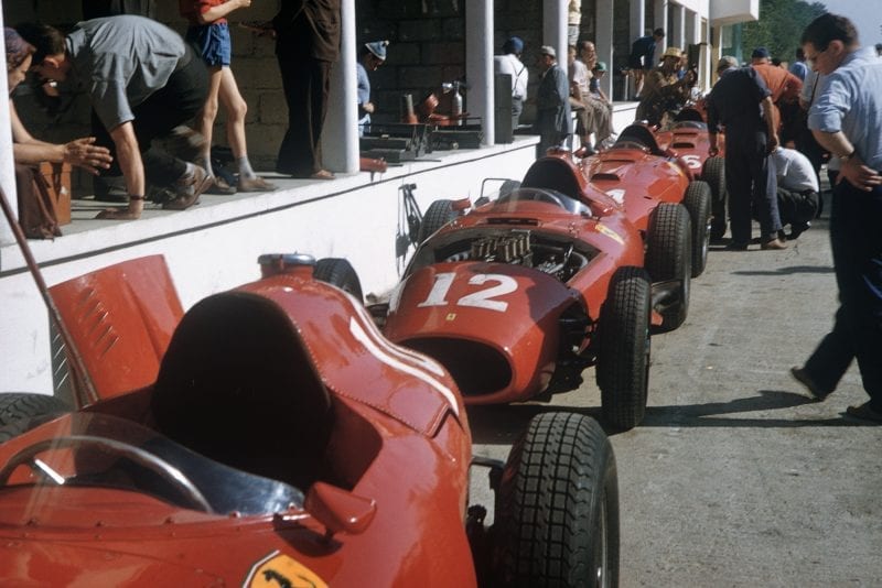 The Lancia-Ferrari 801 chassis of the Scuderia Ferrari team line up astern in the pit lane, ready to be worked on, 1957 French GP, Rouen.