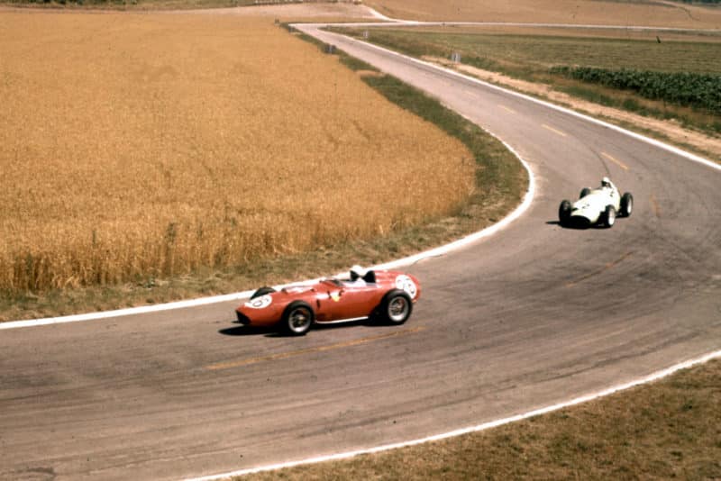 Phil Hill who finished 2nd in a Ferrari Dino 246 leads Stirling Moss in his BRM P25.