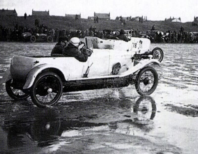 Frazer Nash splashes through puddles in sand race