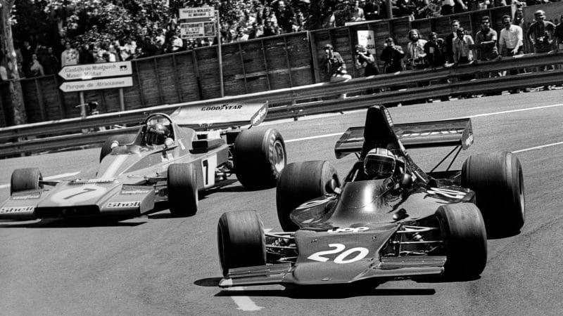 Geiorge Follmer passes Ferrari of Jacky Ickx in his Shadow F1 car