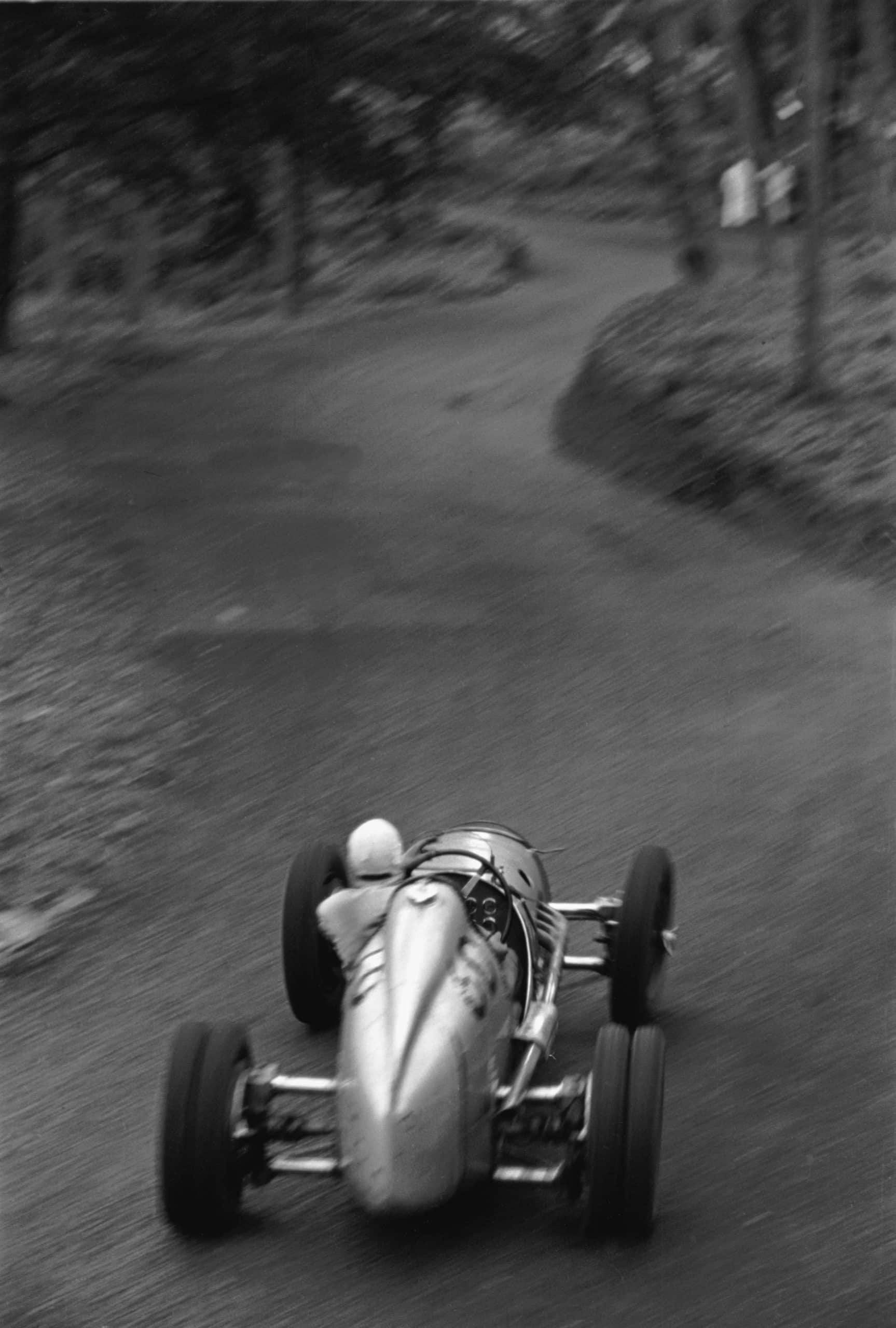 Prescott Hill-Climb, May 14, 1939. George Abecassis roars up into the Esses in his two-liter Alta. In this photo one can see the twisting road ahead and the slide of the car caught by the driver. Much is blurred by motion, but the steeringwheel is in perfect focus. (Photo by Klemantaski Collection/Getty Images)