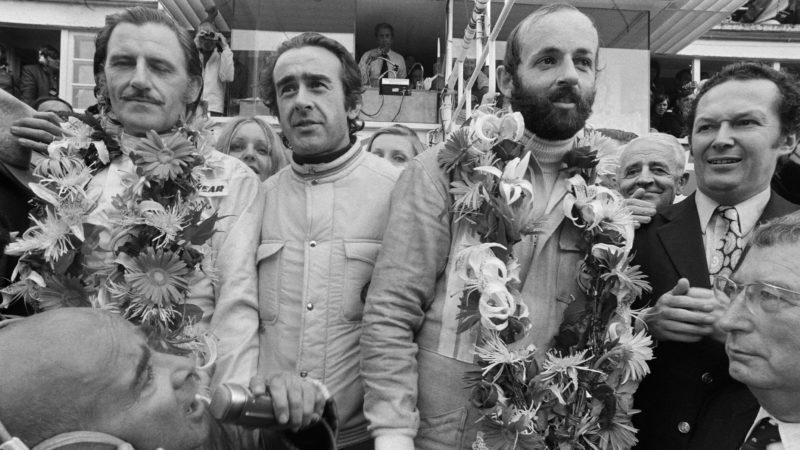 Graham Hill with Jean Luc Lagadere and Henri Pescarolo on the podium at the 1972 Le Mans 24 Hours