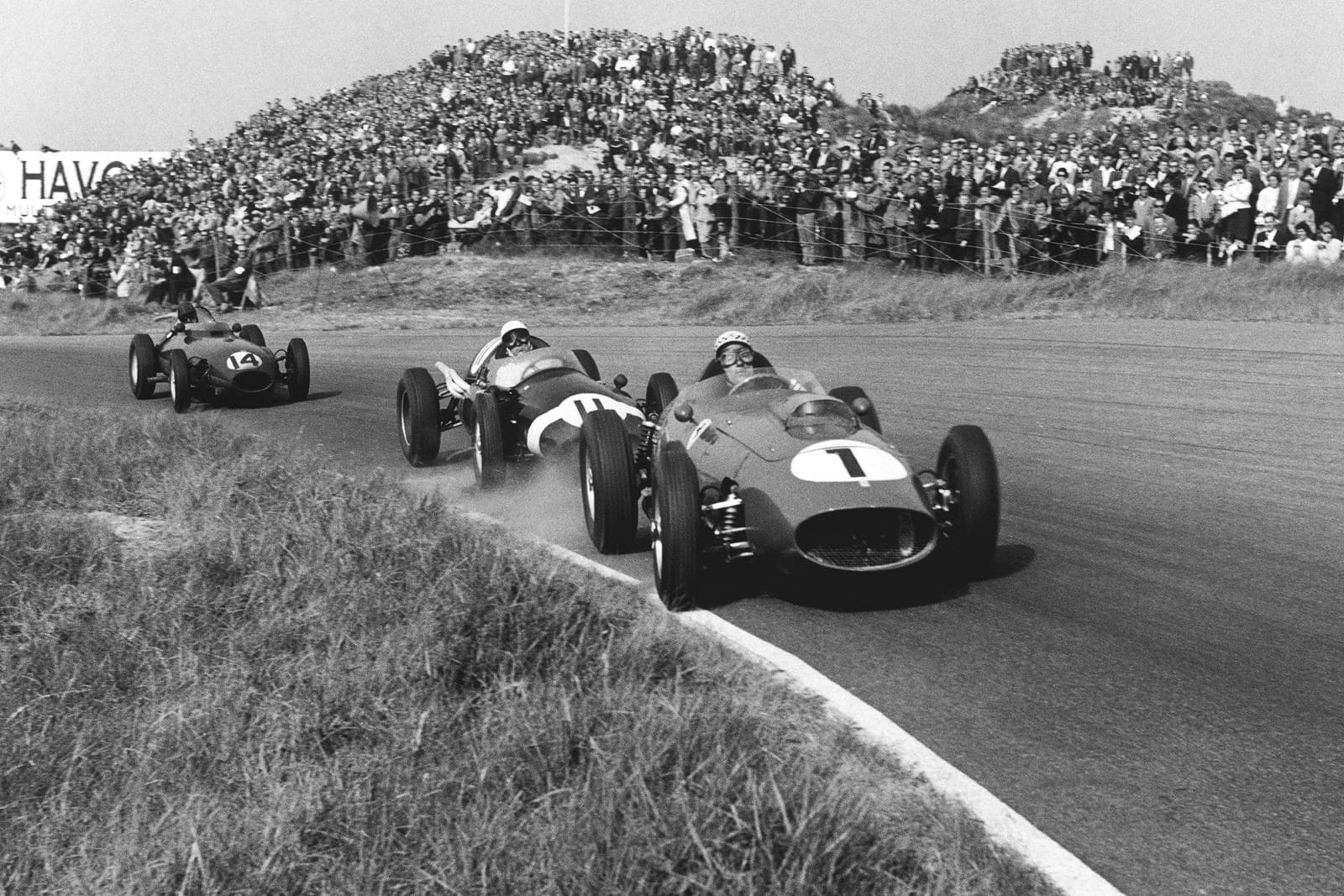 Jean Behra in a Ferrari Dino 246 leads Stirling Moss in a Cooper T51-Climax, and Graham Hill in his Lotus 16-Climax