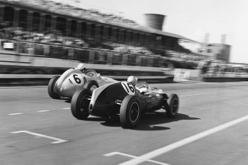 Stirling Moss in his BRM P25 passes Bruce McLaren in a Cooper-Climax T45.
