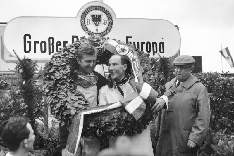 Wolfgang von Trips (Ferrari Dino 156) and Stirling Moss (Lotus 18/21-Climax) celebrate on the podium.
