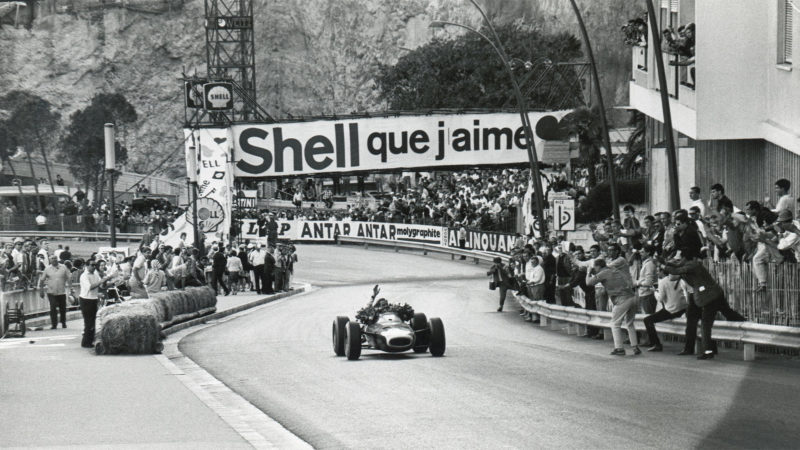 MONTE CARLO, MONACO - MAY 10: Graham Hill waves to the crowd while taking a victory lap after winning the 1964 Monaco Grand Prix at the Circuit de Monaco on May 10, 1964 in Monte Carlo, Monaco. (Photo by Robert Riger/Getty Images)