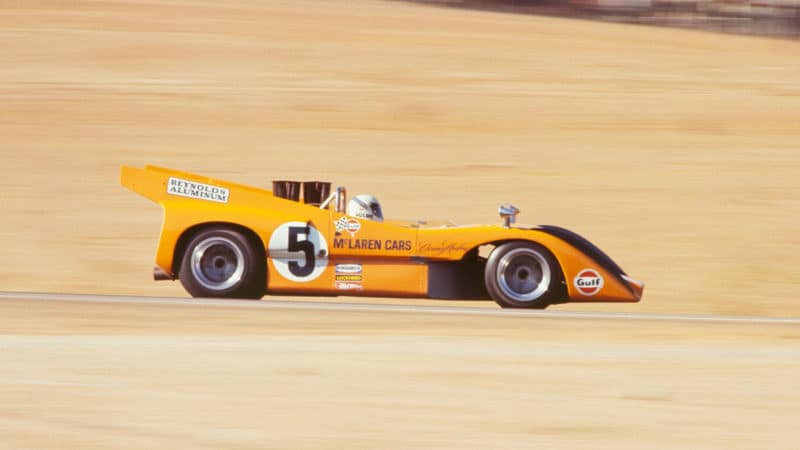 UNITED STATES - JANUARY 01: 1970 Can-Am Races - Riverside - Laguna Seca. Race winner Denny Hulme of McLaren racing drives his McLaren M8D. (Photo by Fred Enke/The Enthusiast Network via Getty Images/Getty Images)