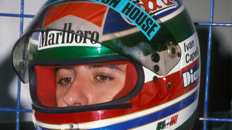 Ivan Capelli looks out from behind his helmet at Estoril testing in 1989