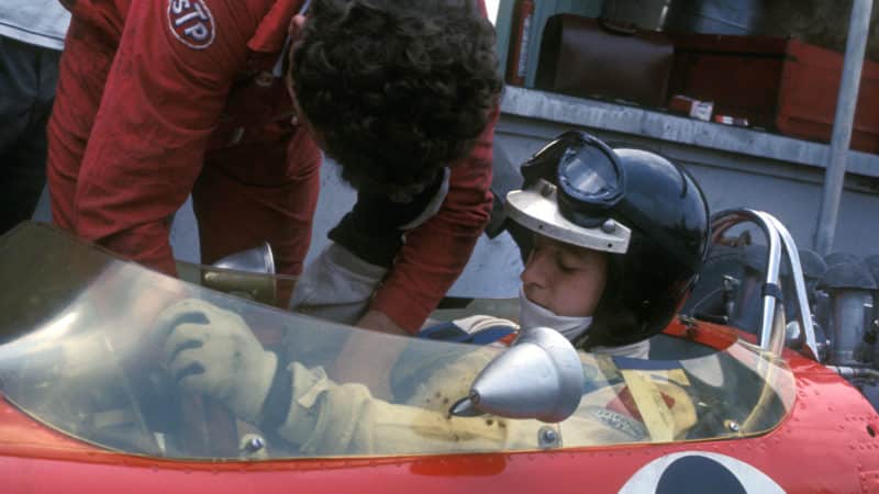 Jackie Oliver sits in his Lotus in the pitlane at 1968 British GP practice